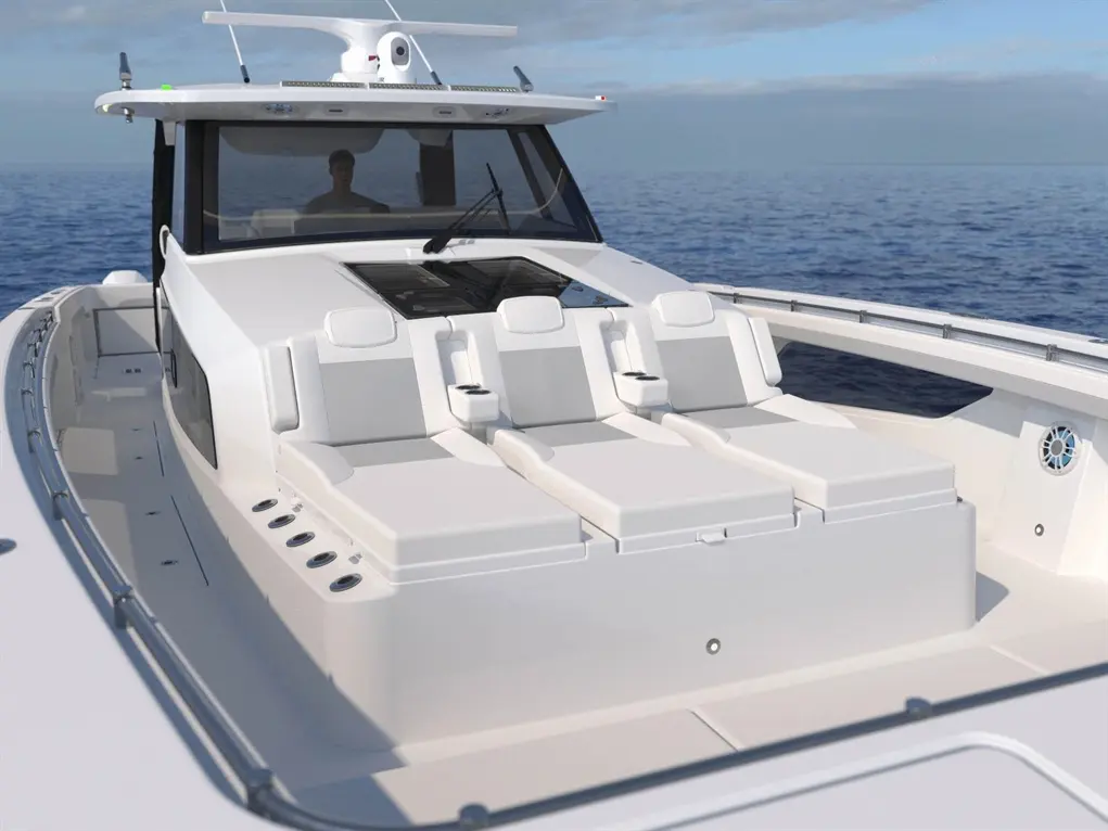 A sleek white boat's cockpit features three reclining seats and a driver in the cabin, with calm ocean waters in the background.